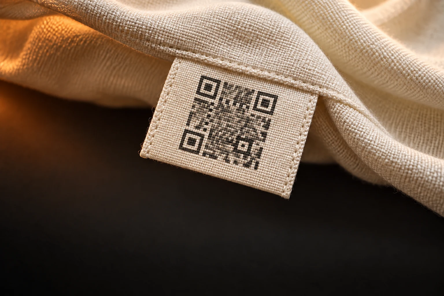 Illustrative QR motif printed on a woven garment label